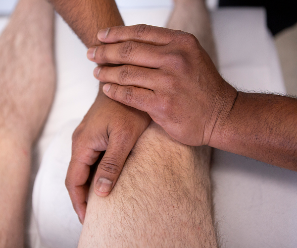 physiotherapist treating knee injury