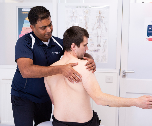 physiotherapist treating shoulder injury